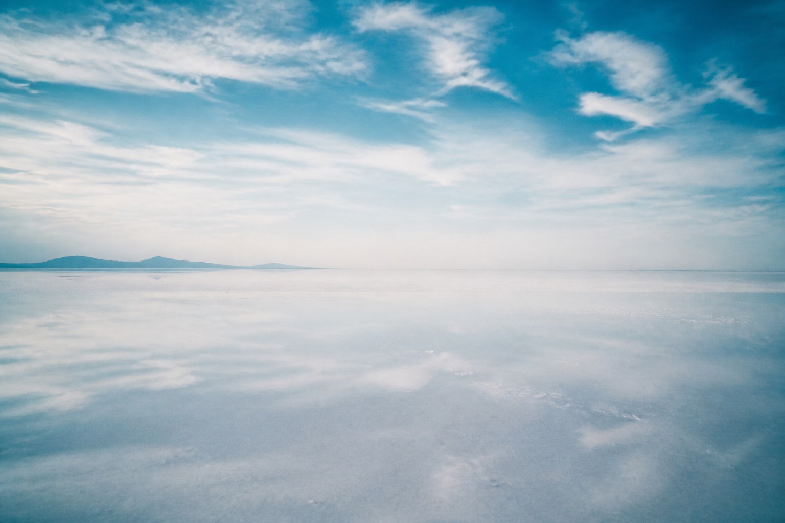 A salt flat or sea horizon where earth and sky meet