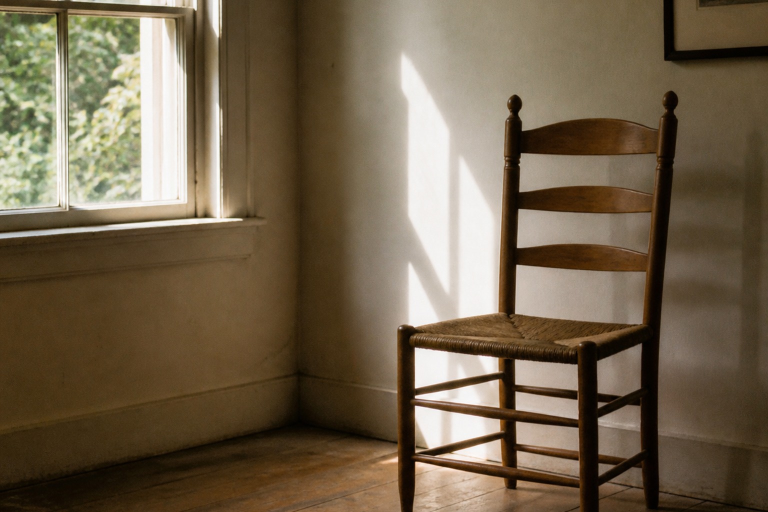 A quiet room with an empty chair by a window